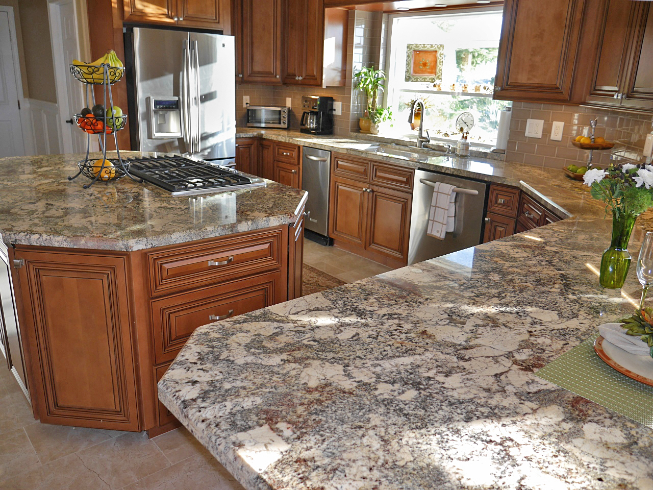 Traditional warm kitchen with cherry cabinets, dramatic granite, and glass tile backsplash